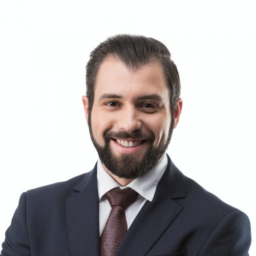 cheerful-bearded-businessman-in-suit-with-crossed-arms-isolated-on-white-e1627749098330.jpg